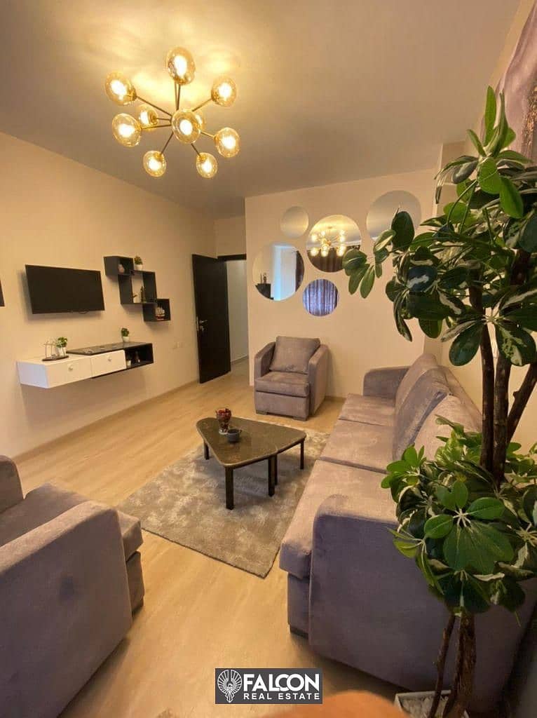 For sale, a finished apartment with a garden, with air conditioners, in the heart of Sheikh Zayed, next to Hyperion, in the VILLAGE WEST compound, in